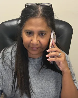 A Hyperion Medical team member taking a service call at her desk