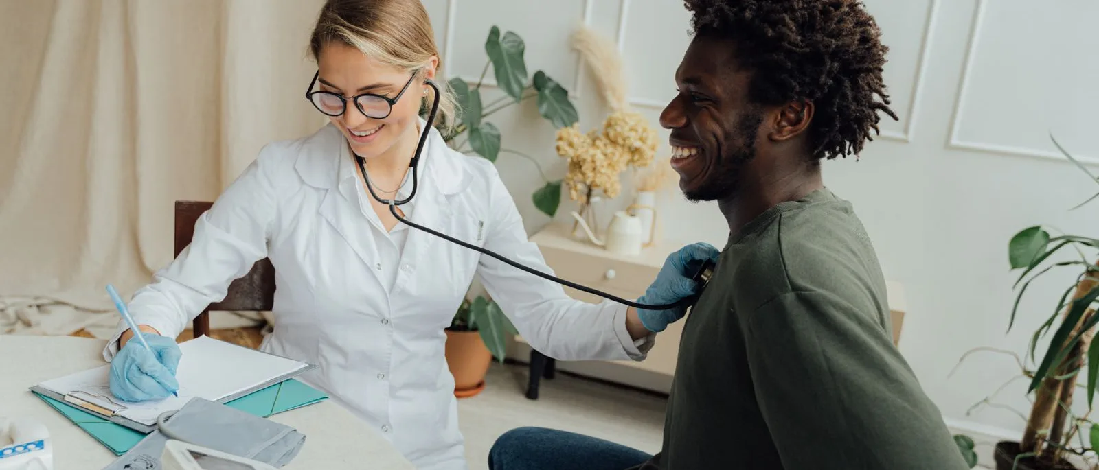 Clinician and patient talking across a desk in a treatment room