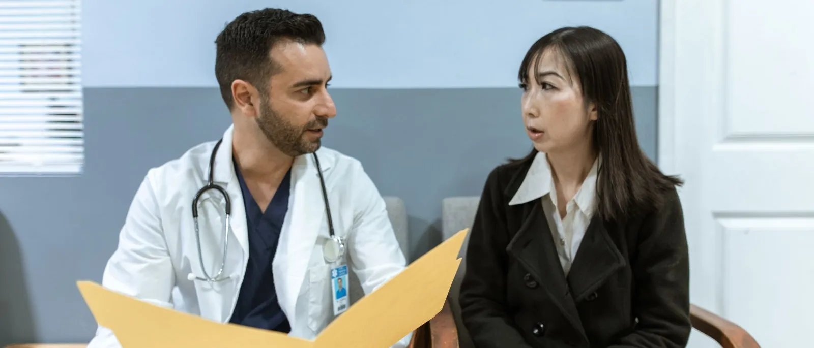 Clinician and client reviewing a document folder together