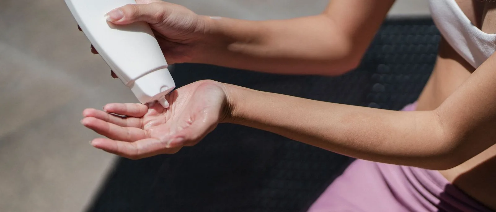 Sunscreen being dispensed into a hand